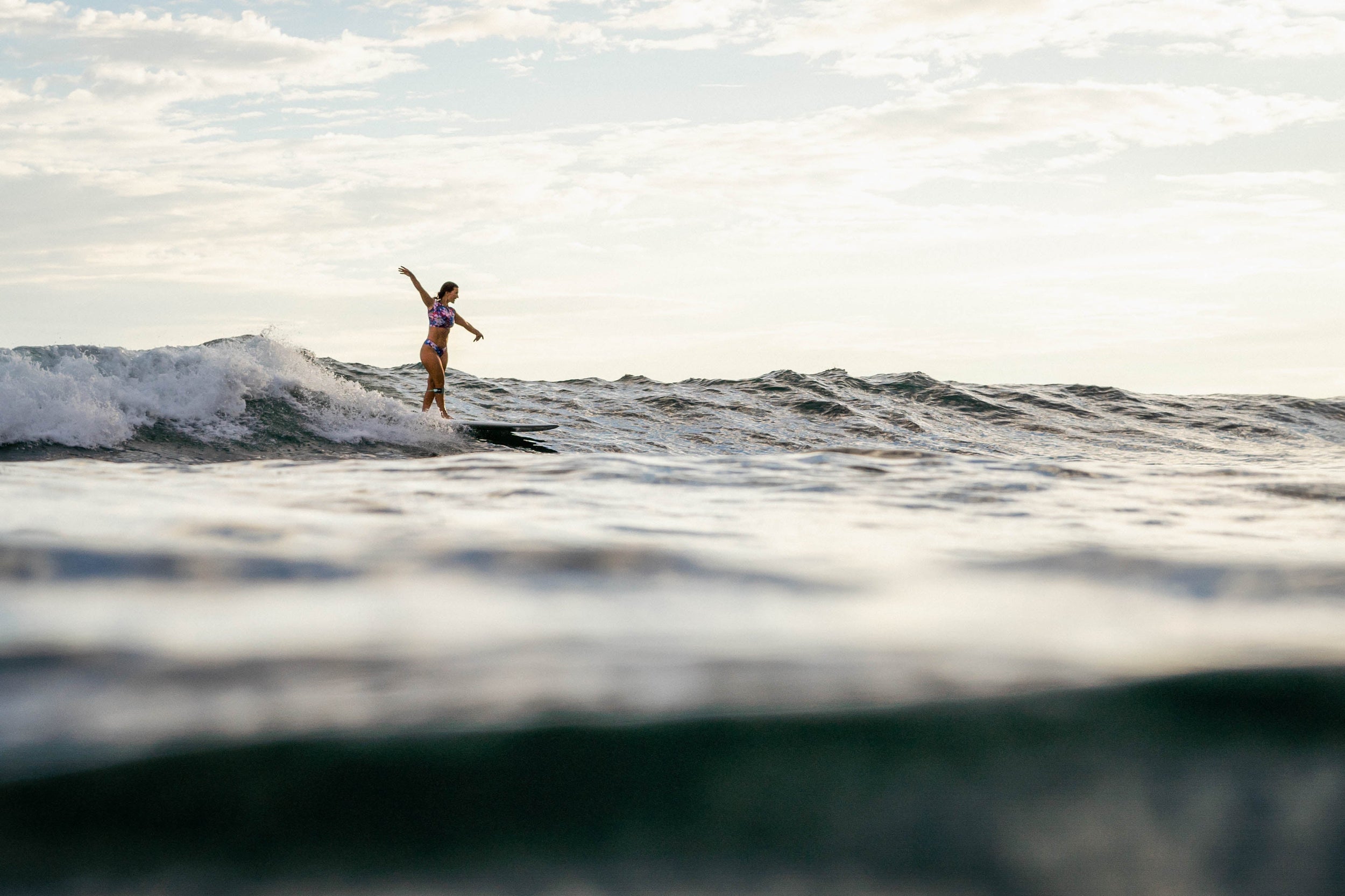Girl surfing in sunset